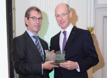 John Swinney MSP, Deputy FM (right), presented the award to Dr Nigel Kerby