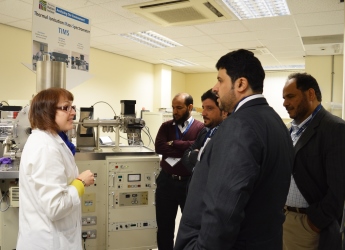 Visitors appreciating the Thermal Ionisation Mass Spectrometer in Aberdeen