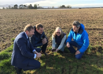 Colin Campbell, Matt Gorman, Helaina Black and Stewart Arbuckle look at soil