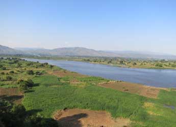 River in Malawi surrounded by fields