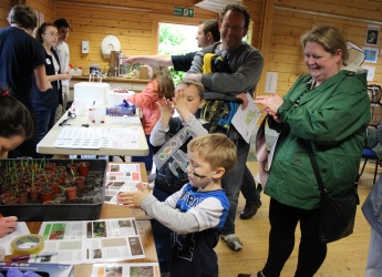 Dr Davide Bulgarelli explains the power of plants to a young visitor