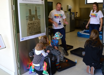 Visitors participating building their own sand towers and learning about soil