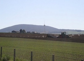 View over fields towards a hill