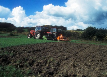 Photograph showing a tractor applying sewage sludge