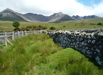 A photograph of the Scottish countryside with mountains in the background