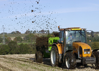 Image showing tractor and trailer carrying out muck spreading