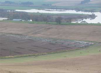 Photograph of agricultural fields alongside a river