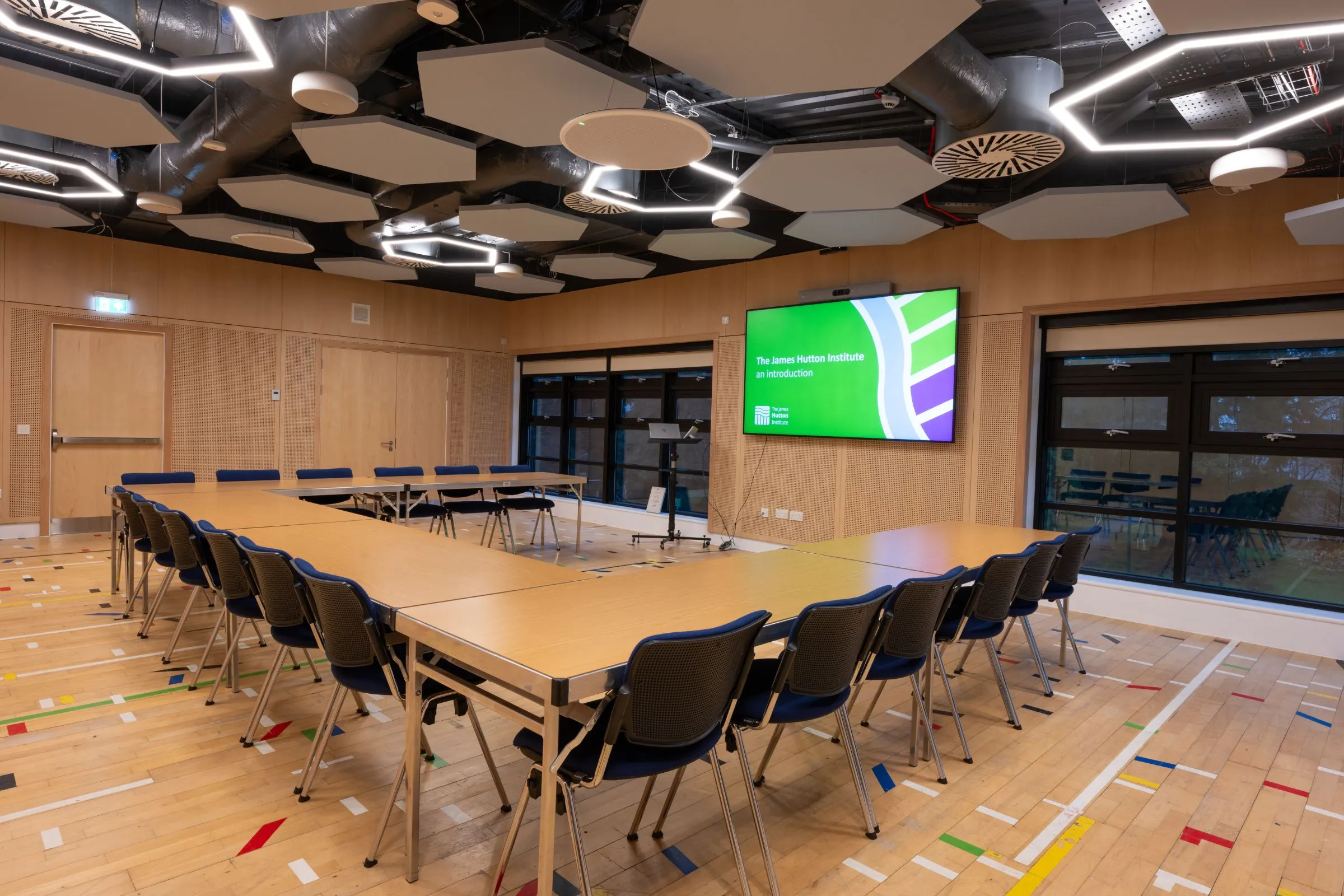 Conference Suite 1A and 1B set out in a U-shaped boardroom layout with a presentation screen