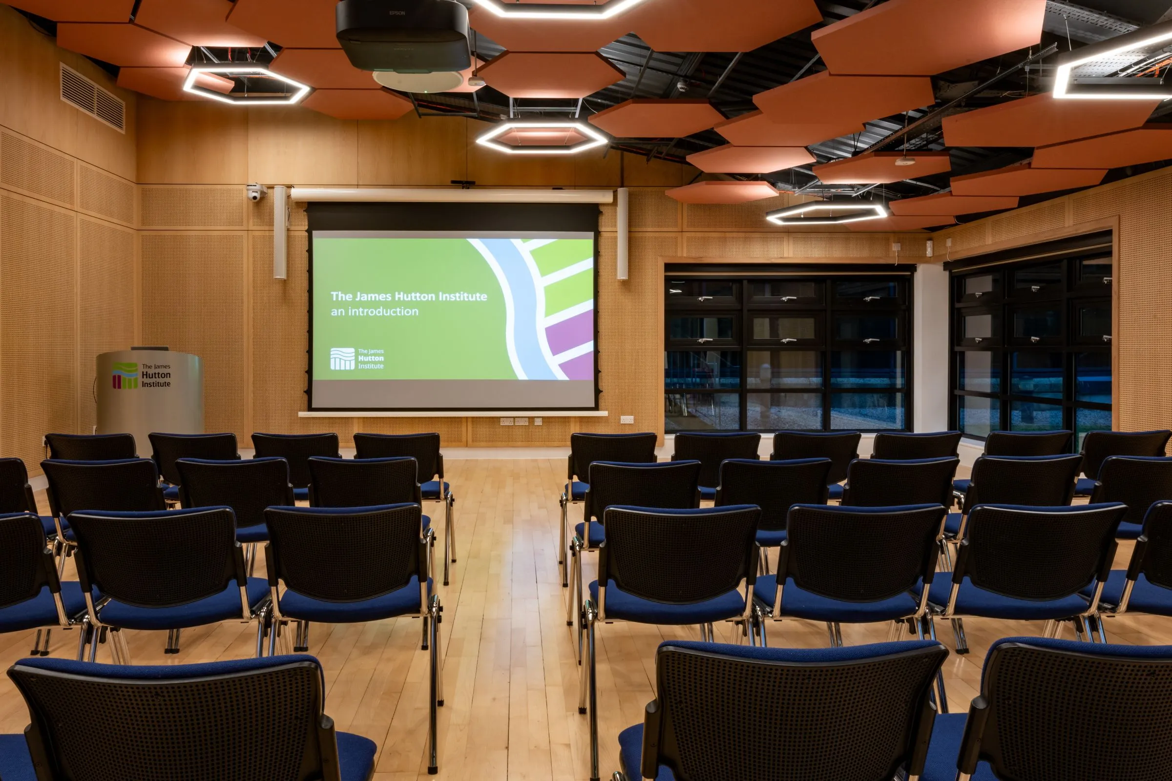 Conference Suite 2 at the Hutton Hub set out theatre style, with rows of seats facing a projector screen and lectern